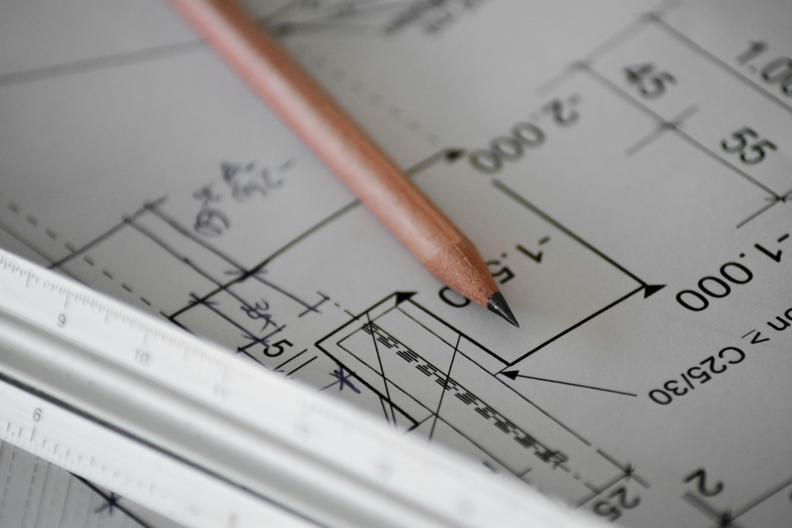 Architectural drawings and drafting tools on a design studio desk